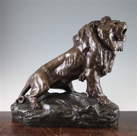 A French Art Deco patinated metal model of a lion, 16in.